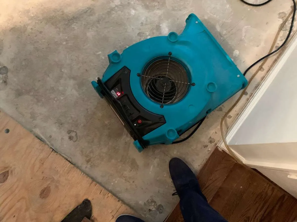 Air mover drying subfloor during Commercial Water Damage Restoration in Jerome